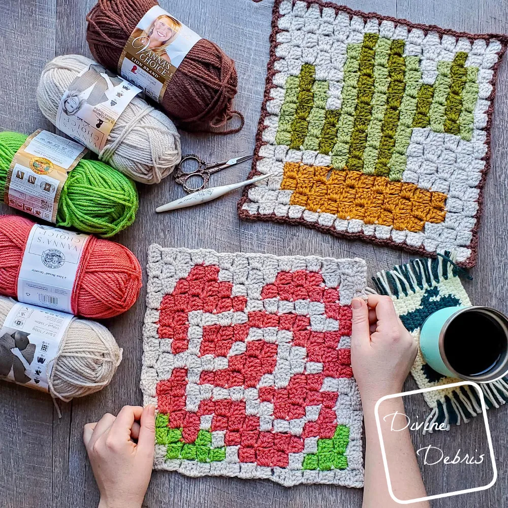 [Image description] C2C Rose Afghan Square held in 2 hands, C2C afghan square on the top right, and matching skeins of yarn along the left.