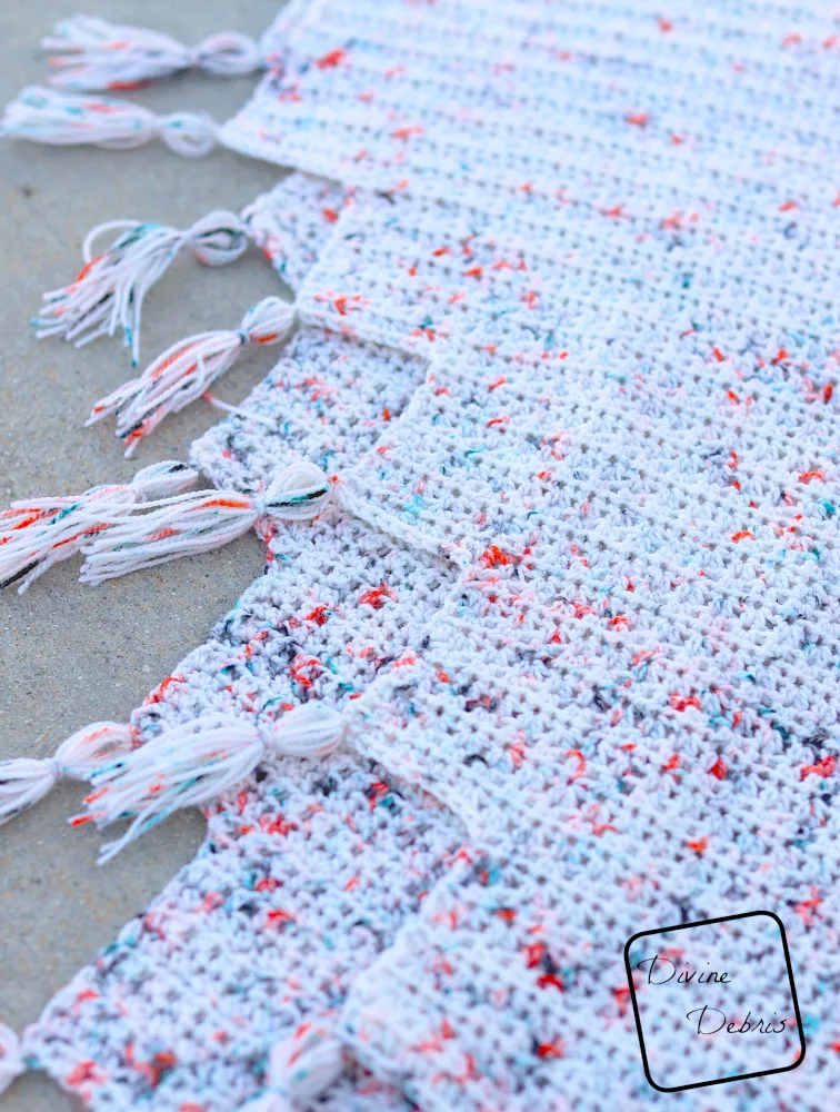[Image description]Close up of the tassels on the corners of the white Lois Shawl.