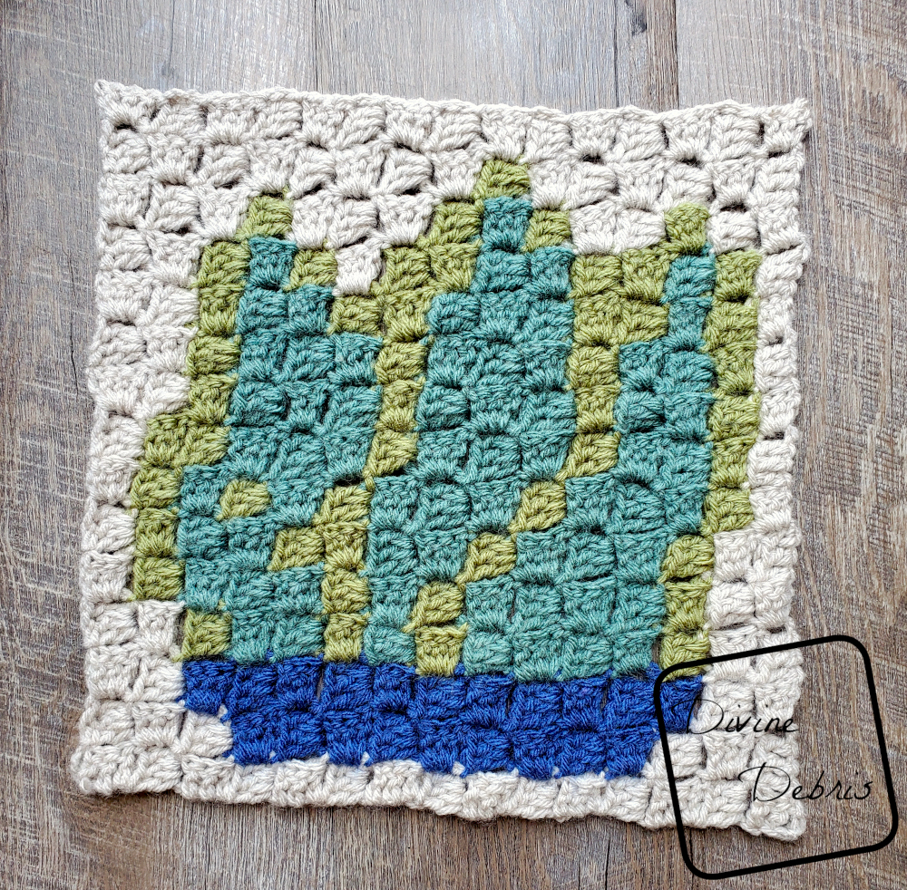 [Image description] the C2C Agave Square lays half-finished flat on a wood grain background