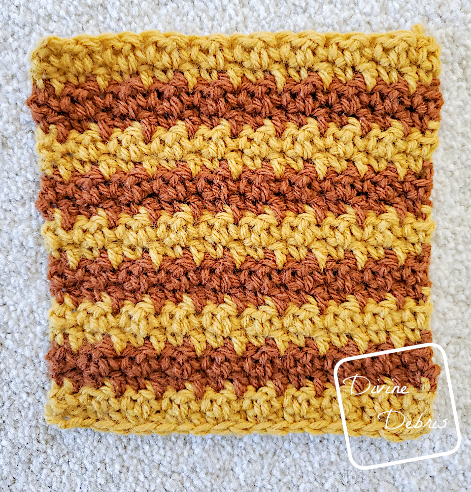 [Image description] Flat lay of Square #2 of the Kelsey Cocoon Shrug crochet pattern on a white carpet background