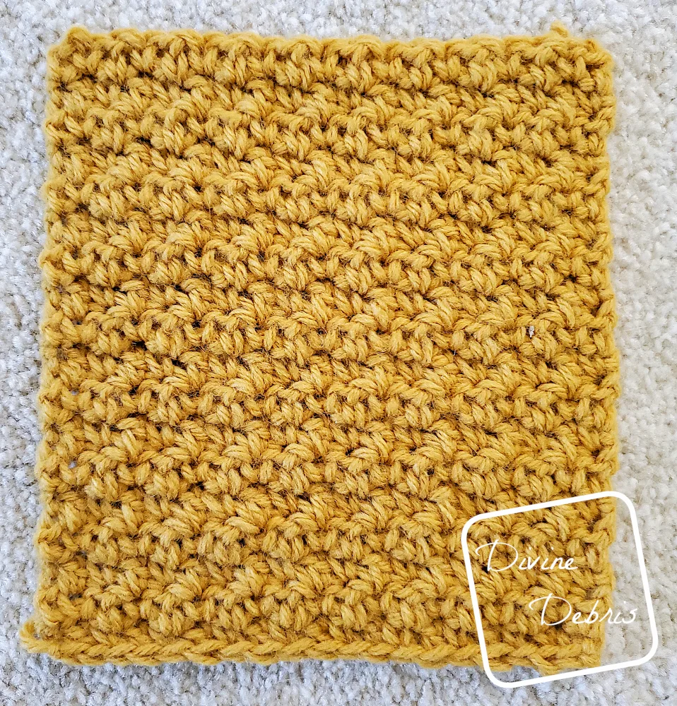 [Image description] Flat lay of Square #1 of the Kelsey Cocoon Shrug crochet pattern on a white carpet background
