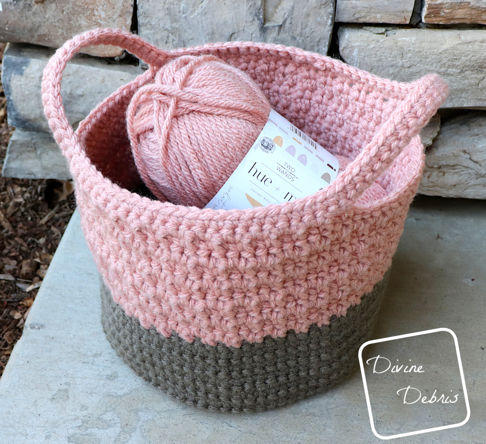 [Image description] A slight top down look at the Lila Basket sitting on stone, with a view of a skein of yarn in the basket.