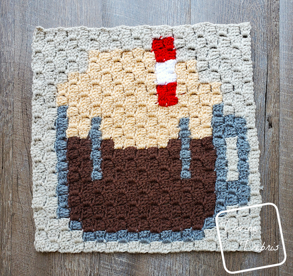 [Image Description] top down view of the C2C Root Beer Float Afghan Square on a wood grain background.