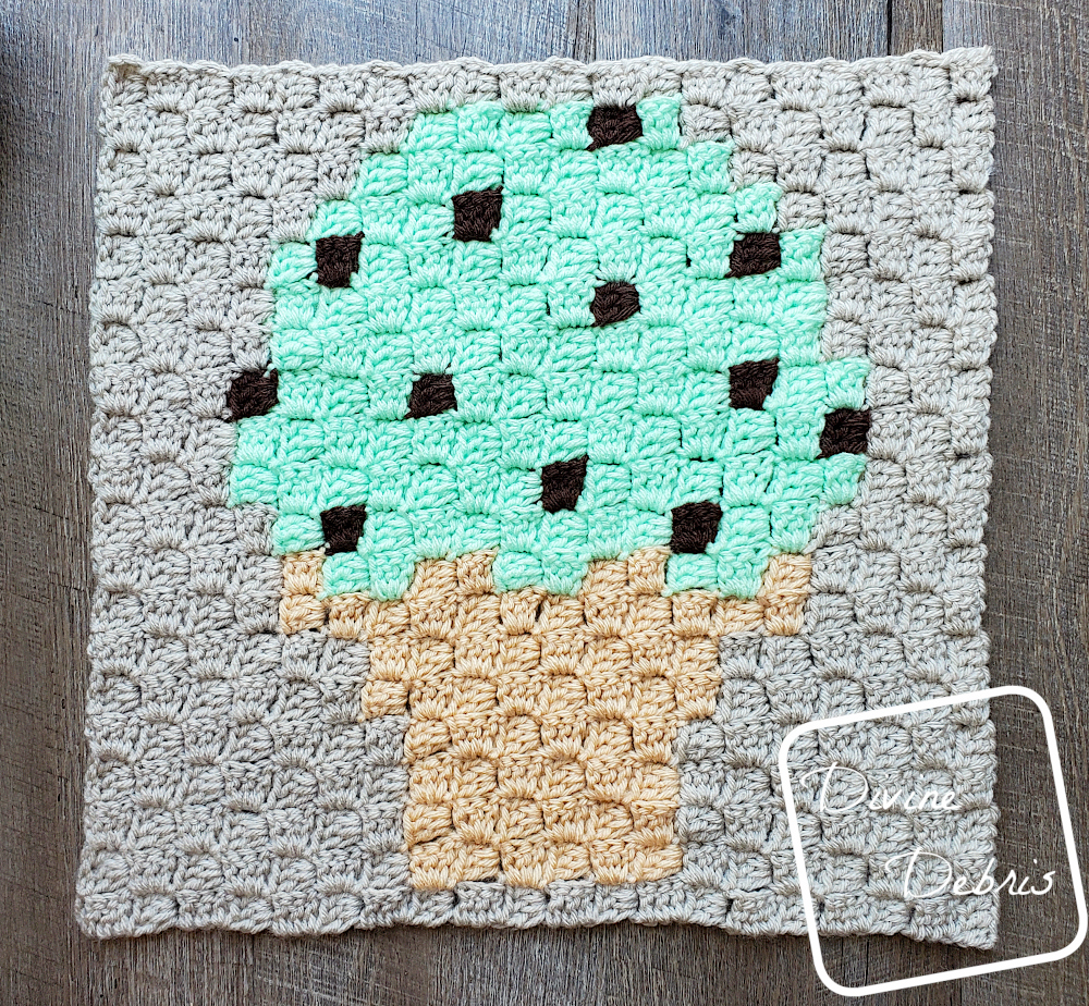 [Image description] C2C Ice Cream cone Afghan Square laying flat on a wood grain background 