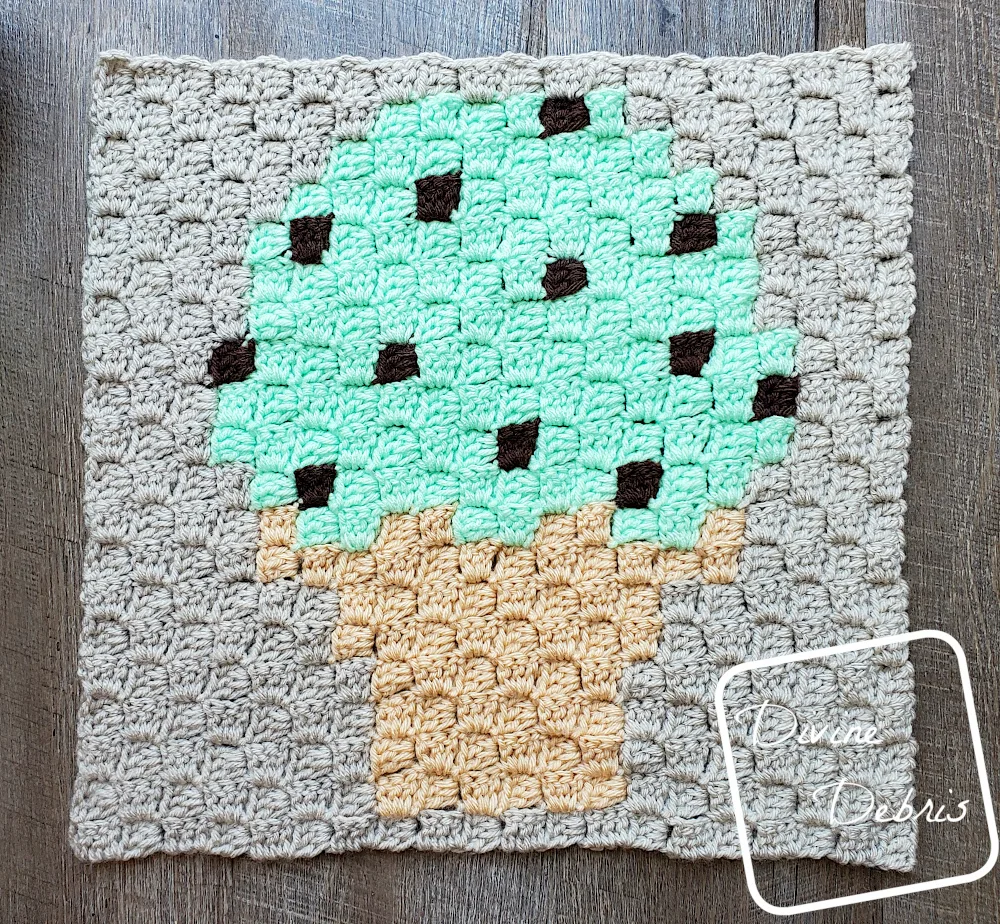 [Image description] C2C Ice Cream cone Afghan Square laying flat on a wood grain background 
