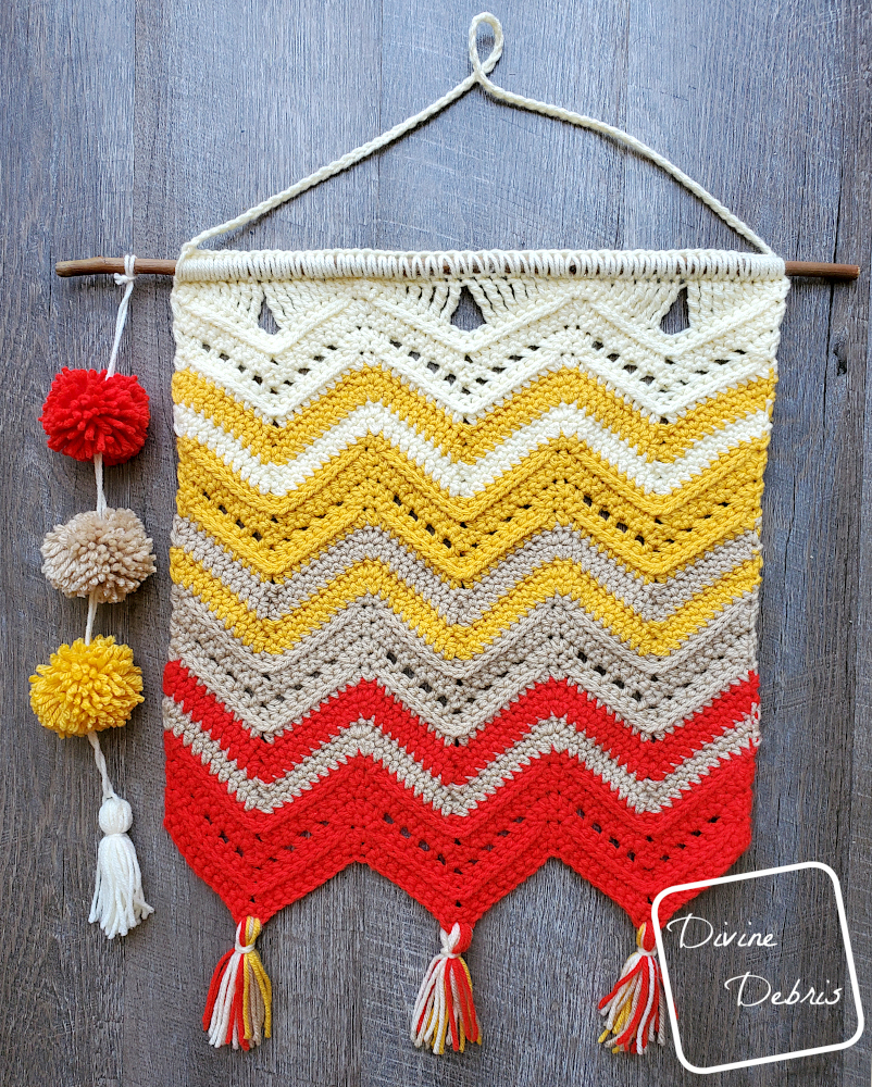 [Image description] The Colorful Chevrons Wall Hanging lays flat on a wood grain background