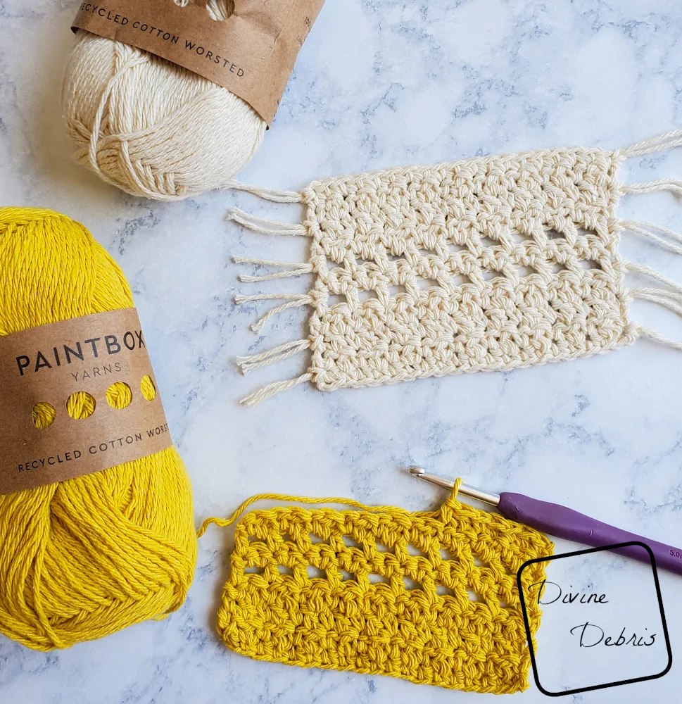 [Image description] close up of a half finished Kieran Mug Rug in yellow, with a crochet attached, and a skein of yarn to the left and a finished mug rug in cream on the top.