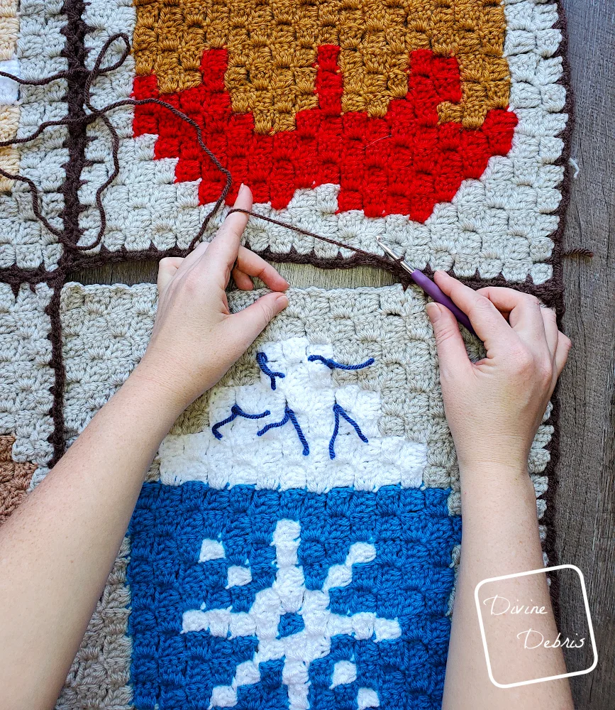 [Image description] Top down view of a pair of white woman's hands seamed together 2 c2c squares