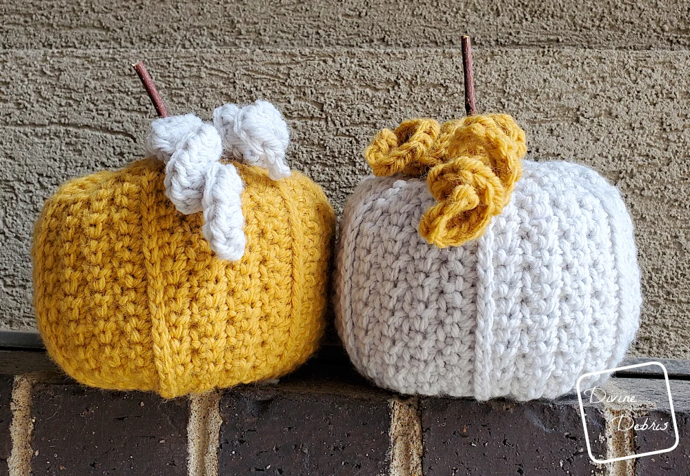 [Image description] 2 Keeley Pumpkins, one yellow and one gray, sitting on a brick row against a tan wall