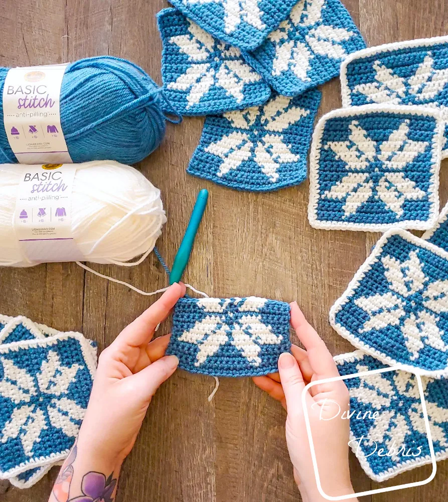 [image description] top down look of Susie Snowflake Bag squares with a white woman's hands holding an unfinished square. 