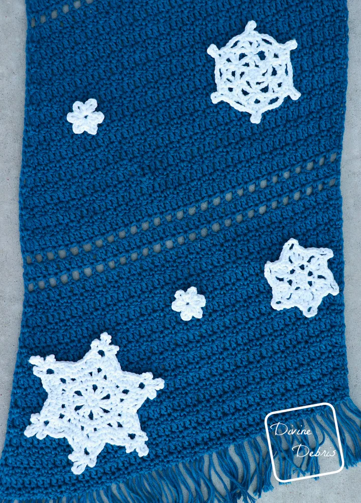 [Image description] A top down view of the Crystal Snowflakes Shawl on a gray background showing the placement of the snowflakes.