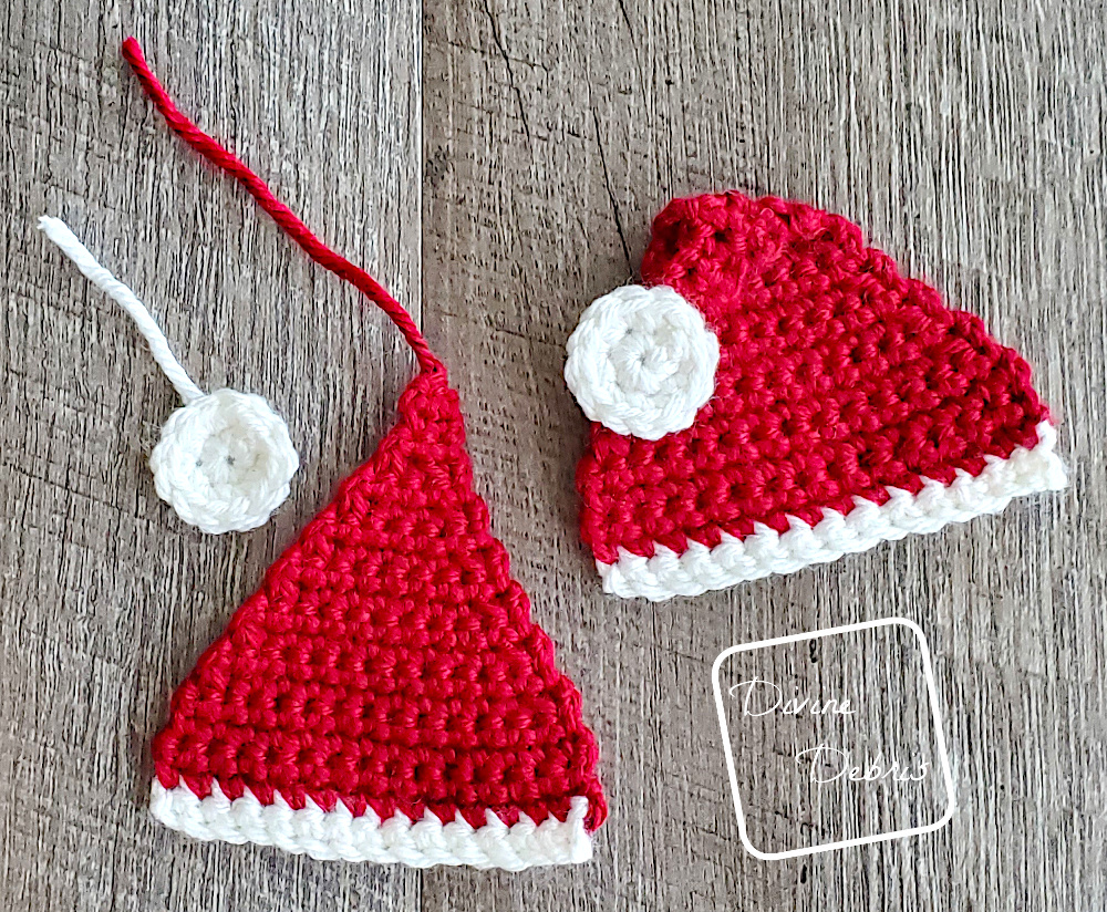 [Image description] Top down look at 2 Santa Hat Appliques on a fake wood background, with one not finished being assembled.