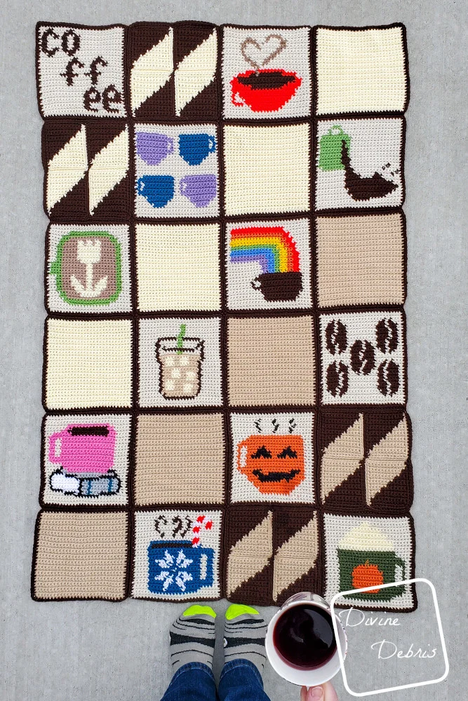 [image description] top down view of the Coffee Squares Lapgahn all seamed with a woman's feet and white woman's hand holding a cup of coffee on the bottom of the photo.