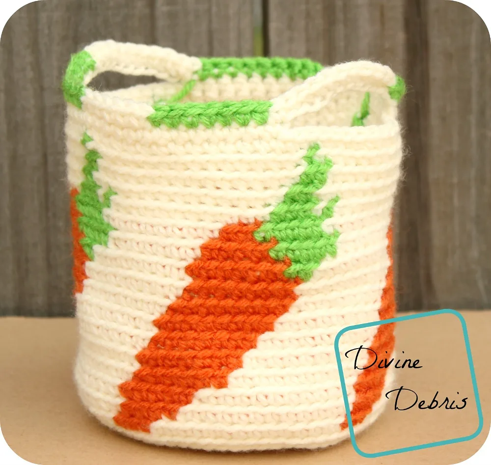 [Image description] Cute Carrots Basket sitting against a wooden fence.