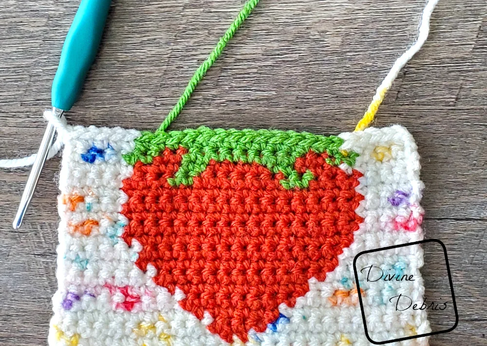 [image description] close up look of the right side of a Cute Strawberry Bag square on a fake wood background