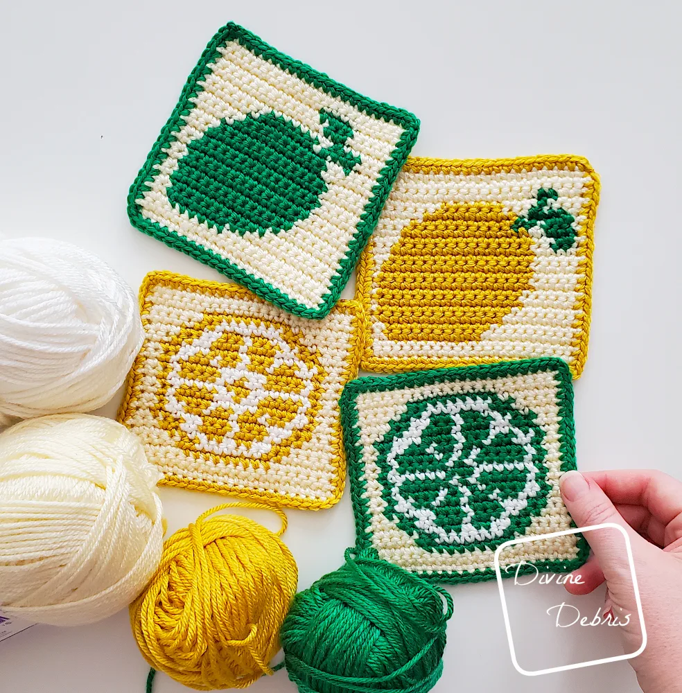 [Image description] Cute Lemons Squares and Cute Lime Squares on a white background with yarn along the left side of the photo and a white woman's hand holding a right most square