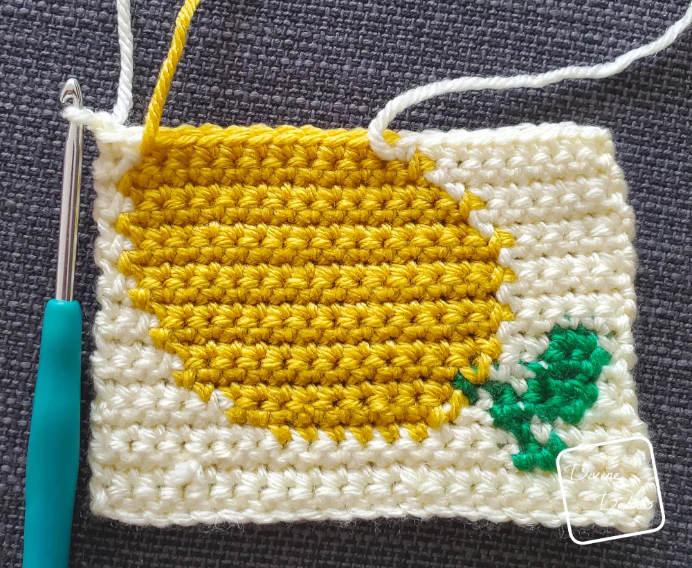 [image description] close up look of the wrong side of the Lemon Square from the Citrus Crush Bag square on a fabric background