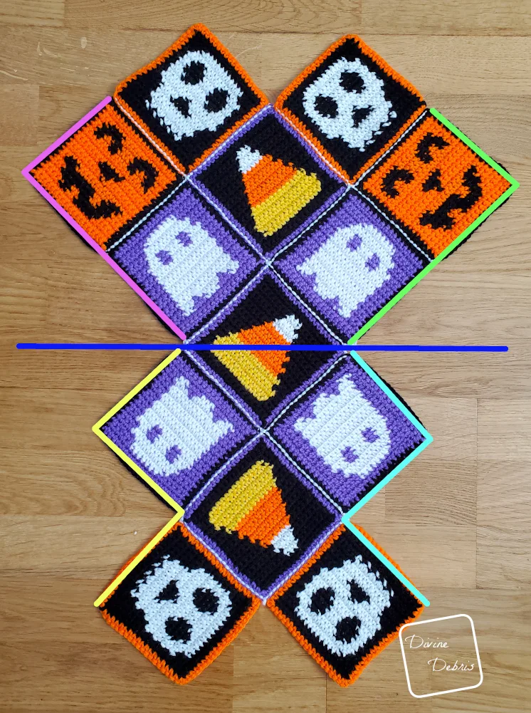 [Image description] Patchwork Halloween Bag assembly photo 1 - all 13 squares are seamed and are laying on an wooden background, color coded for where to seam next.