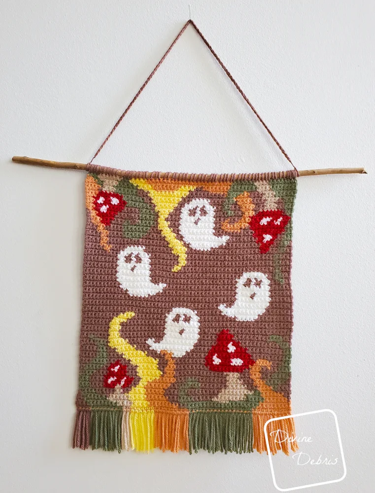 Phantom Fungus Wall Hanging free Halloween crochet pattern hangs on white wall. 