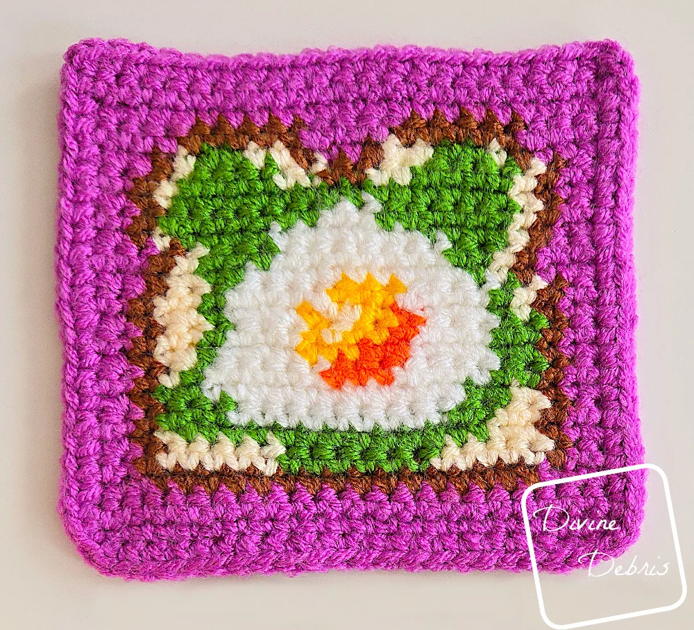 [Image description] the Avocado Egg Crochet Square laying on a white background.