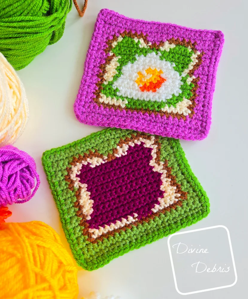 [Image description] The Avocado Egg and Jam Toast Squares laying on a white background with skeins of yarn along the left side of the frame.