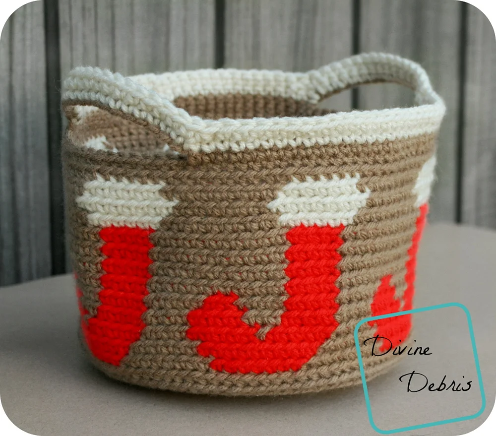 Joyful Stocking Basket Crochet Pattern on a tan shelf against a wood background