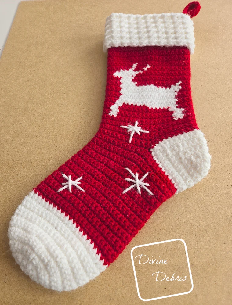 [Image description] A low angle look at the Twinkle Toes Reindeer Stocking on a tan background.