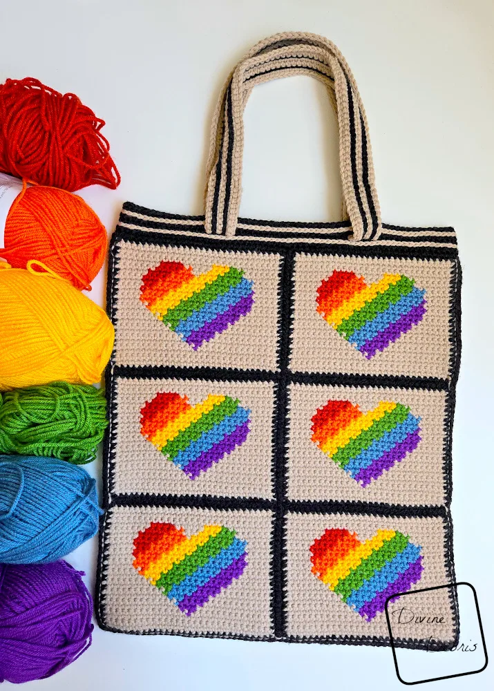 [Image description] Top down view of the Back Panel of the Be Brave Bag on a white background with a rainbow of skeins of yarn along the left side of the photo.