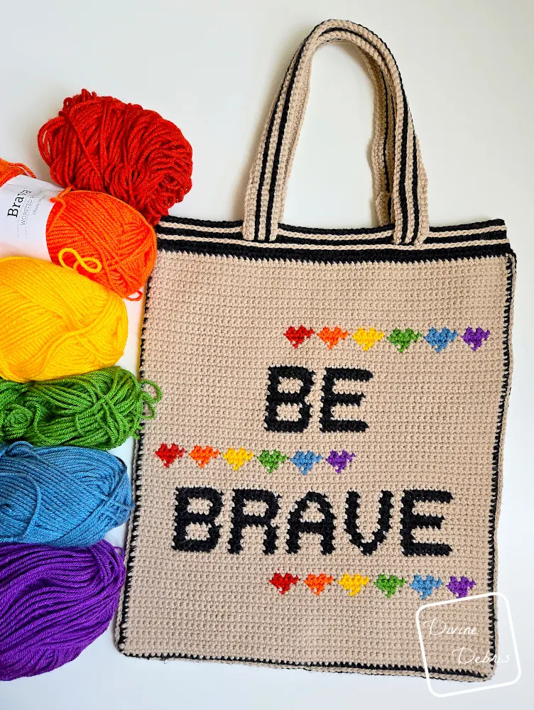 Top down view of the Be Brave Bag on a white background with a rainbow of colors along the left side of the photo.