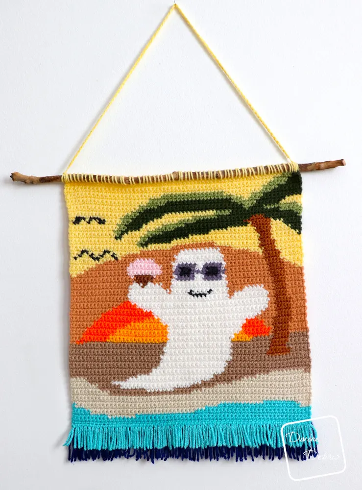 [Image description] The Beach Ghost Wall Hanging hangs on a white wall.