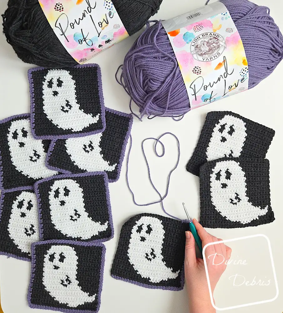 [Image description] Top down view of Gwendoline Ghost Squares unfinished with a white woman's hand working on the border of one.