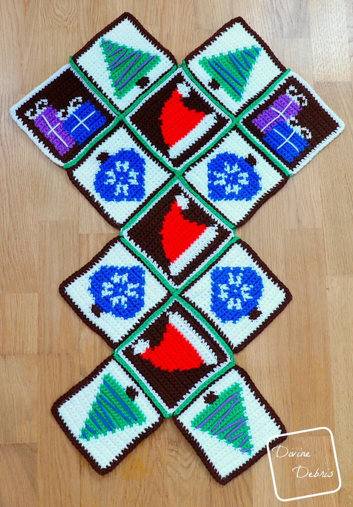[Image description] Patchwork Christmas Bag assembly photo 1 - all 13 squares are seamed and are laying on an wooden background
