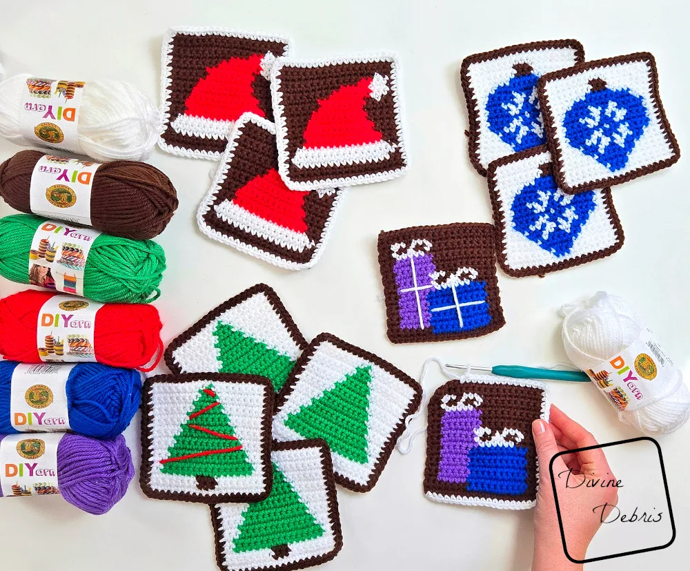 [Image description] Top down look at a a collection of squares for the Patchwork Christmas Bag, some unfinished, with a white woman's hand holding an unfinished bag on the bottom right.